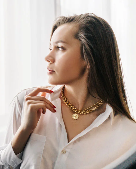 Woman with long dark hair wearing a white shirt and gold necklace. - Q Sqitched Laser in Hermosa Beach, CA